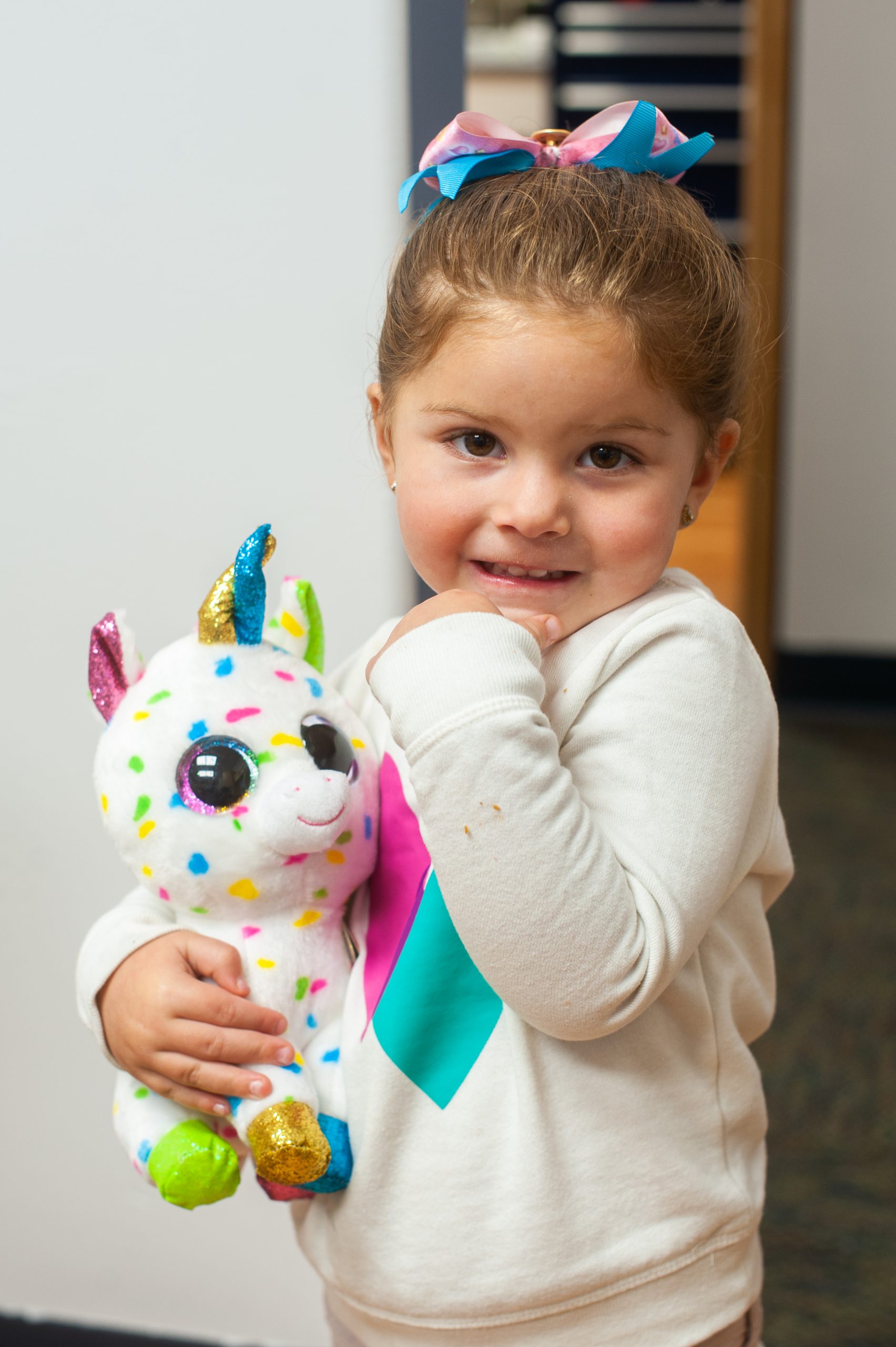 Little girl holding stuffed animal